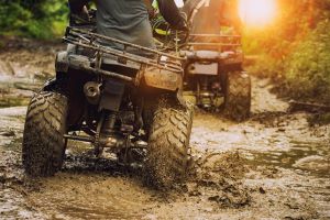 Atv driving through mud