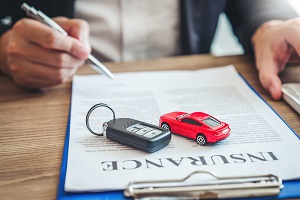 car keys on car insurance paperwork