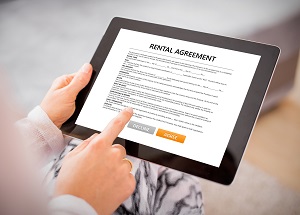 woman reading rental agreement on tablet