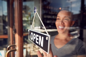 restaurant owner turning open sign