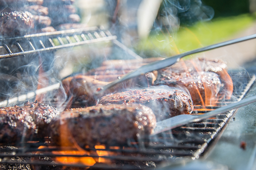 a close up of steaks on a grill